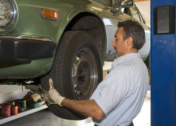 bigstockphoto_Changing_A_Tire_930495